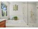 Serene bathroom featuring a soaking tub, walk-in shower with glass door, and stylish decor at 4029 Gift Blvd, Johns Island, SC 29455
