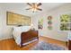 Bright bedroom with wooden floors, a decorative rug, and a large window offering natural light at 4029 Gift Blvd, Johns Island, SC 29455