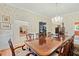 Formal dining room with a large wooden table, chandelier, and wallpaper, ideal for hosting dinner parties at 4029 Gift Blvd, Johns Island, SC 29455