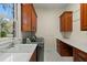 Laundry room features a sink, workspace, storage cabinets, and stainless steel washer and dryer at 4029 Gift Blvd, Johns Island, SC 29455