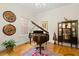 Sophisticated living room featuring a grand piano, hardwood floors, and elegant decor, perfect for entertaining at 4029 Gift Blvd, Johns Island, SC 29455