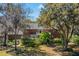 Rear view of an impressive brick home with lush landscaping, a small balcony and a well-maintained lawn at 4029 Gift Blvd, Johns Island, SC 29455