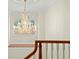 Ornate crystal chandelier illuminates the staircase landing, showcasing elegant design and architectural details at 4029 Gift Blvd, Johns Island, SC 29455