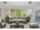 AI rendering of sunroom featuring natural light and backyard views at 4029 Gift Blvd, Johns Island, SC 29455