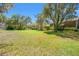 Large grassy backyard with mature trees, offering ample space for outdoor activities and relaxation at 4029 Gift Blvd, Johns Island, SC 29455