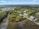 An aerial view showcases the community's marsh-front property with mature trees, scenic views, and convenient access to waterways at 4060 S Rhett Ave, North Charleston, SC 29405