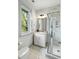 Bathroom with a shower, vanity, and window overlooking a tree at 4060 S Rhett Ave, North Charleston, SC 29405
