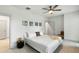 Bright bedroom featuring a comfortable bed, ceiling fan, and minimalist decor at 4060 S Rhett Ave, North Charleston, SC 29405