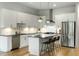 Modern kitchen featuring white cabinets, stainless steel appliances, and a stylish island with pendant lighting at 4060 S Rhett Ave, North Charleston, SC 29405