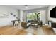 Bright living room with modern decor, hardwood floors, and large windows offering scenic views at 4060 S Rhett Ave, North Charleston, SC 29405