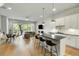 Open-concept living space with a modern kitchen, comfortable seating, and natural light from large windows at 4060 S Rhett Ave, North Charleston, SC 29405