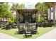 Inviting outdoor event space featuring a central stage, rocking chairs, and lush greenery for a relaxed atmosphere at 4060 S Rhett Ave, North Charleston, SC 29405