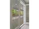 View from inside a home, through French doors, showcasing a covered balcony with wood floors and white railings at 4235 Royal Harbor Rd, Hollywood, SC 29449
