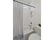 Bathroom with a white shower curtain, built in shelves, white tiled walls and black metal hardware at 4235 Royal Harbor Rd, Hollywood, SC 29449