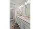 Well-lit bathroom features double sinks, modern fixtures, and a shower-tub combination with gray patterned tile at 4235 Royal Harbor Rd, Hollywood, SC 29449