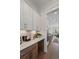 Butler pantry with white cabinets and stone countertops that connects to the dining room at 4235 Royal Harbor Rd, Hollywood, SC 29449