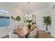 Bright dining area with hardwood floors, wainscoting, a chandelier, and chic dining table at 4235 Royal Harbor Rd, Hollywood, SC 29449