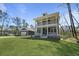 Exterior shot of a two-story home with a detached garage and manicured lawn at 4235 Royal Harbor Rd, Hollywood, SC 29449