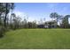 A house with two stories and a large yard and a detached garage on a clear day at 4235 Royal Harbor Rd, Hollywood, SC 29449