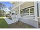 Charming home entrance with white railing, steps, and walkway leading to a covered front porch at 4235 Royal Harbor Rd, Hollywood, SC 29449