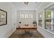 Well-lit office space with hardwood floors, a modern desk, a comfortable chair and large windows at 4235 Royal Harbor Rd, Hollywood, SC 29449