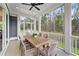 Outdoor porch with a ceiling fan, dining table set, and view of the trees at 4235 Royal Harbor Rd, Hollywood, SC 29449