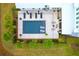 Aerial view of a backyard pool with lounge chairs and surrounding lush landscaping and outdoor seating areas at 4310 Stonehouse Cir, Awendaw, SC 29429