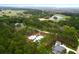 Aerial view of an estate surrounded by lush greenery with a beautiful lake at 4310 Stonehouse Cir, Awendaw, SC 29429