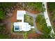 A top-down aerial view of a modern home with a pool, complemented by mature trees and a winding driveway at 4310 Stonehouse Cir, Awendaw, SC 29429