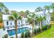 A picturesque backyard featuring a modern white home, a sparkling pool, and lush palm trees for a tranquil retreat at 4310 Stonehouse Cir, Awendaw, SC 29429