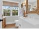 Bright bathroom with a large window, custom mirror and accents, and white vanity at 4310 Stonehouse Cir, Awendaw, SC 29429