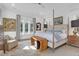 Bright main bedroom with a four-poster bed, neutral decor, and large windows at 4310 Stonehouse Cir, Awendaw, SC 29429