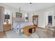Spacious bedroom with a four-poster bed, wood floors, and comfortable sitting area at 4310 Stonehouse Cir, Awendaw, SC 29429