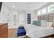 Spacious primary bedroom with king bed, wooden floors, stylish furniture, and bright natural light at 4310 Stonehouse Cir, Awendaw, SC 29429