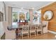 Elegant dining room with a long wooden table, fabric chairs, and views of the pool at 4310 Stonehouse Cir, Awendaw, SC 29429