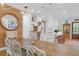 Dining area featuring a long wooden table with white chairs and modern chandelier lighting at 4310 Stonehouse Cir, Awendaw, SC 29429