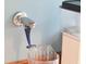 Close-up of a vintage-style chrome water dispenser with a blue handle and a clear plastic cup at 4310 Stonehouse Cir, Awendaw, SC 29429