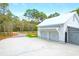 Spacious three-car garage features white exterior, ample driveway space, and access to the main road at 4310 Stonehouse Cir, Awendaw, SC 29429