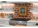 Modern kitchen features white countertops, stainless steel range, and brick backsplash with rustic decor at 4310 Stonehouse Cir, Awendaw, SC 29429