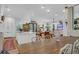 Bright open-concept kitchen with white cabinetry and large island that overlooks the living and dining area at 4310 Stonehouse Cir, Awendaw, SC 29429
