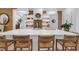 Island kitchen featuring a white countertop, seating, open shelving, and brick backsplash at 4310 Stonehouse Cir, Awendaw, SC 29429