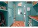 Bright laundry room featuring a washer/dryer, red brick floors, and ample storage at 4310 Stonehouse Cir, Awendaw, SC 29429