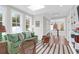Stylish living room with green sofa, decorative pillows, neutral rug, and natural light from windows and skylight at 4310 Stonehouse Cir, Awendaw, SC 29429