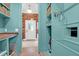 Well-organized mudroom with charming aqua cabinetry and brick-look floors at 4310 Stonehouse Cir, Awendaw, SC 29429