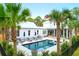 Backyard oasis with pool, lounge chairs, umbrellas, palm trees, and privacy fence at 4310 Stonehouse Cir, Awendaw, SC 29429