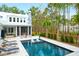Beautiful pool with in-pool loungers surrounded by lounge chairs and mature landscaping at 4310 Stonehouse Cir, Awendaw, SC 29429