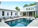 Sparkling backyard pool with lounge chairs, seating areas, and a screened-in porch for relaxation at 4310 Stonehouse Cir, Awendaw, SC 29429