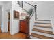 Inviting staircase features wooden treads, white risers, and shiplap walls, complemented by stylish decor at 4310 Stonehouse Cir, Awendaw, SC 29429