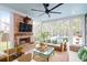 Inviting sunroom with a cozy fireplace, wicker seating, and a view of the outdoor pool at 4310 Stonehouse Cir, Awendaw, SC 29429