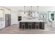Modern kitchen featuring an island with seating, stainless steel appliances, and sleek cabinetry with ample counter space at 5104 Coneflower Ct, Johns Island, SC 29455